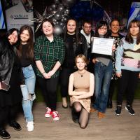 Large group pose on stage. U-turn peer educators. 